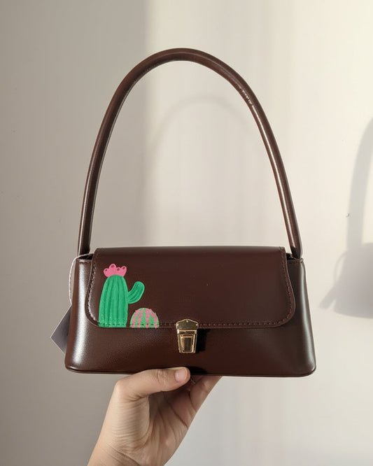Brown shoulder bag with cactus design